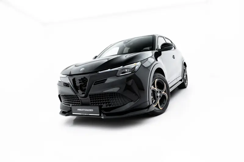 Front-left angled view of a sleek black car in a white studio setting, emphasizing its aggressive grille and low profile, with #MAXTONIZED on the plate.