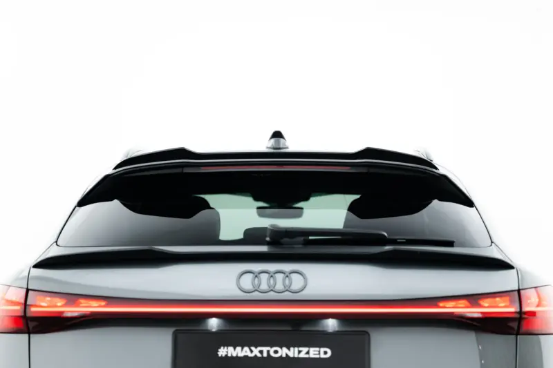 Rear view of a silver Audi SUV showing the trunk and taillights, with the #MAXTONIZED text on the license plate area.