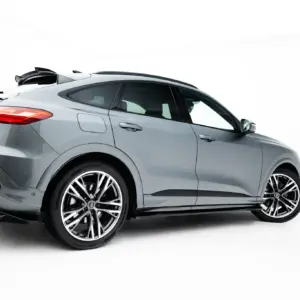 Side-rear view of a silver luxury SUV with large alloy wheels, shown against a white studio background.