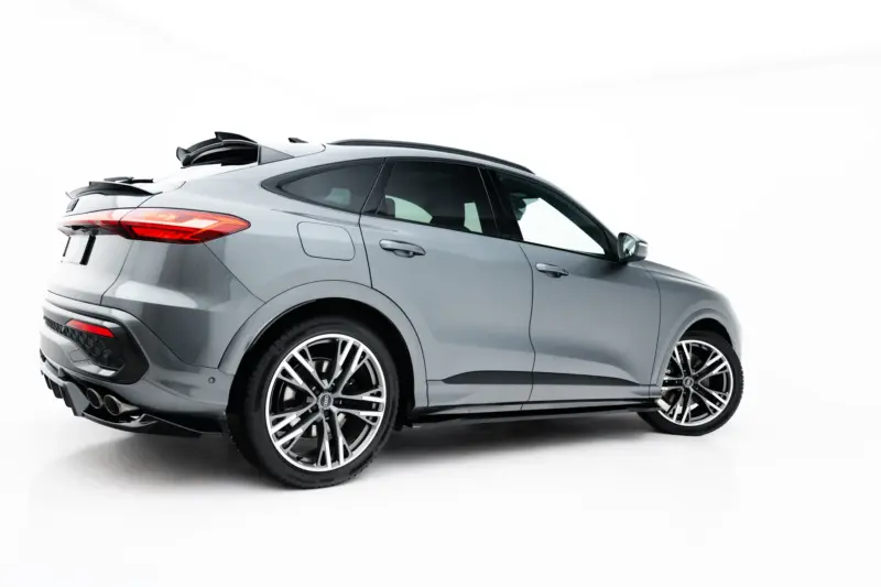 Side-rear view of a silver luxury SUV with large alloy wheels, shown against a white studio background.