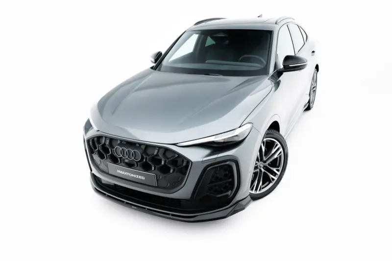 Front-right angled view of a silver Audi SUV, showcasing a bold black grille and large alloy wheels; license plate reads #MAXTONIZED.
