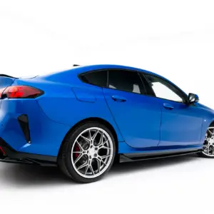 Blue sports car shown from a rear-right angle with large silver alloy wheels on a white background.