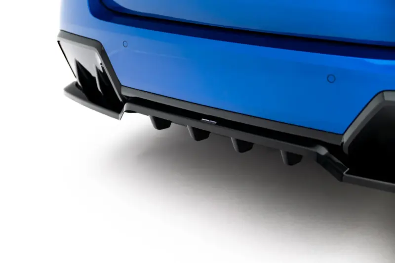 pol_po_Set-of-Splitters-BMW-2-M-Pack-Gran-Coupe-F74-23856_5webp - OPSHOLDERS Close-up of a blue car bumper with a black lower lip and a small Maxton Design badge.