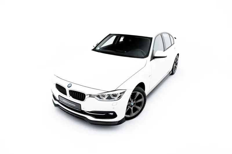 Front three-quarter view of a white BMW car in a bright studio, showing the grille, headlights, and sporty wheels.