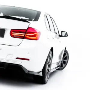Rear view of a white BMW with red taillights and a black license plate area displaying '#MAXTONIZED'