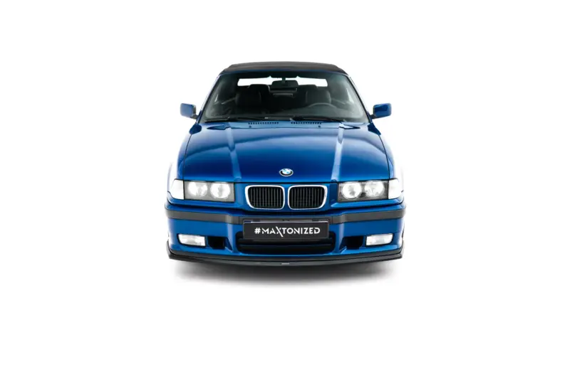 Front view of a blue BMW SUV with a black roof and the hashtag #MAXTONIZED on the license plate