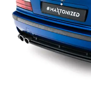 Blue car rear with twin exhaust tips and a black license plate reading #MAXTONIZED.