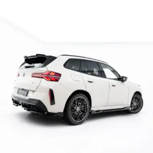 Rear three-quarter view of a white BMW SUV with the tailgate open in a bright studio setting.