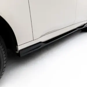 Close-up of a white car's side panel and alloy wheel in a studio setting.