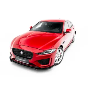 Red Jaguar sedan angled from the front-left against a white background, showcasing its grille and headlights