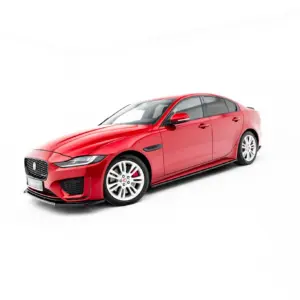 Red Jaguar sedan shown in a studio setting, three-quarter front view with a white background for a clean product shot.