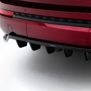 Close-up of a red car rear bumper showing a black diffuser and a small Maxton Design badge.
