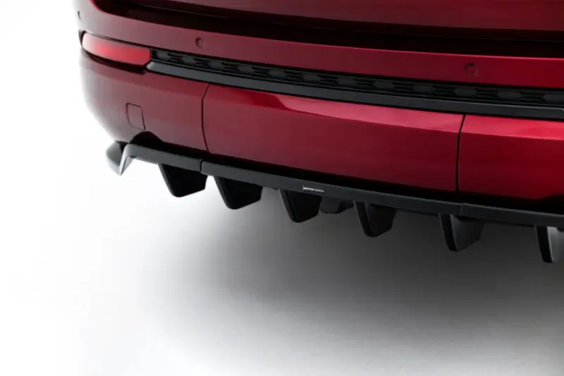Close-up of a red car rear bumper showing a black diffuser and a small Maxton Design badge.
