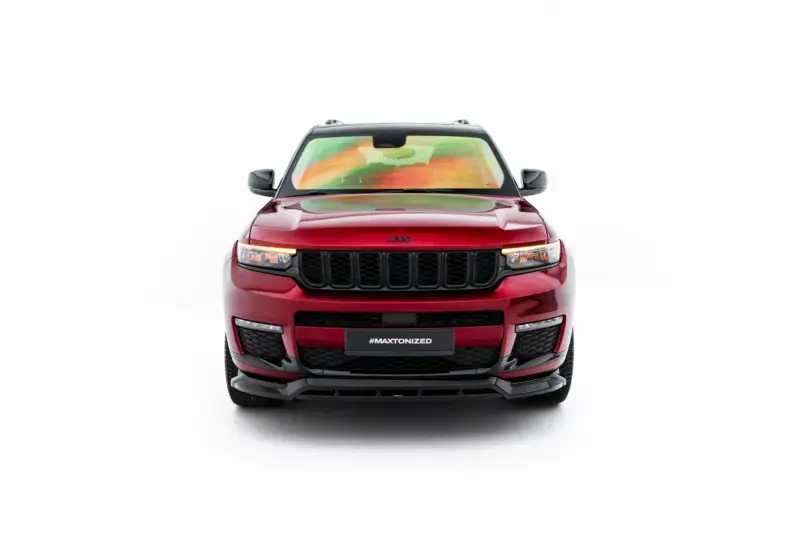 Front-on view of a red Jeep SUV with a black grille and glowing headlights, centered in a white studio background, #MAXTONIZED on the plate area.