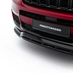 Front end of a red car showing a black grille and a license plate reading #MAXTONIZED on the bumper