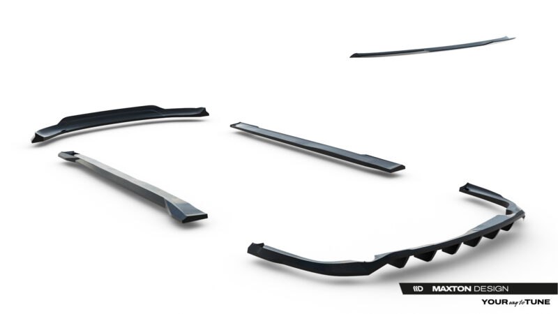 Collection of black automotive aero parts (side skirts and splitters) laid out on a white studio backdrop, showcasing a body kit lineup.