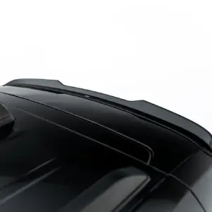 Close-up of a glossy black car roof with curved lines and a small rear spoiler visible at the top edge of the image.