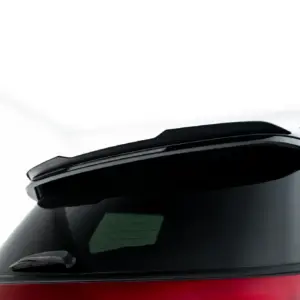Partial view of a car's rear window with wiper, showing dark glass and red body at the bottom edge of the image