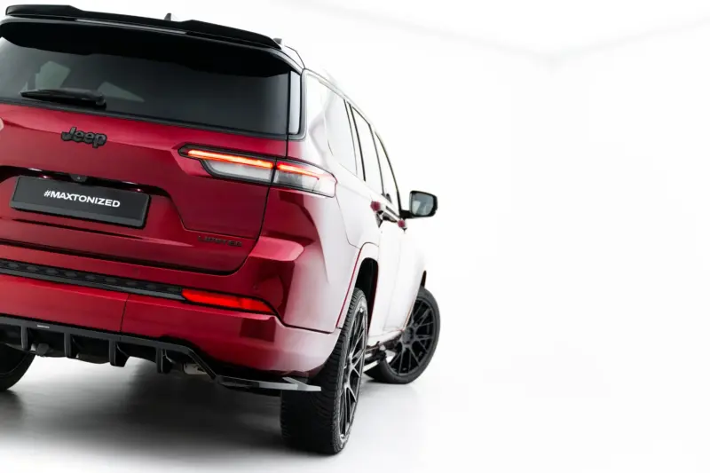 Red Jeep SUV seen from a rear three-quarter angle, showing the taillight, bumper, and a #MAXTONIZED plate on a glossy red finish.