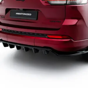 Rear view of a red SUV showing a black license plate with '#MAXTONIZED', and a 'Limited' badge on the tailgate.