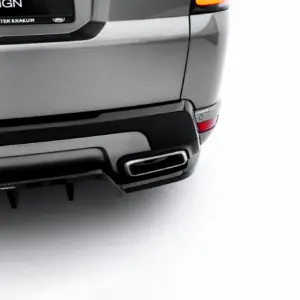 Rear view of a silver SUV, showing the taillight, bumper, and exhaust against a white studio background.