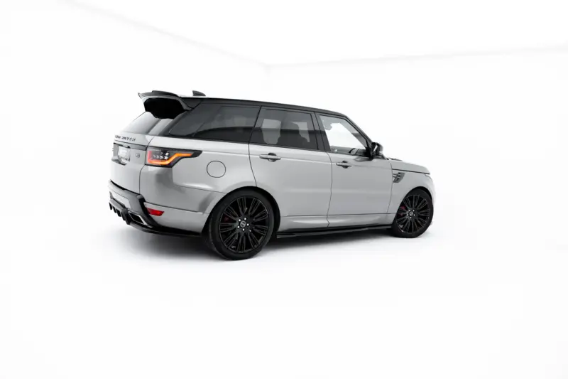 pol_po_Set-of-Splitters-Land-Rover-Range-Rover-Sport-Mk2-Facelift-23834_13webp - OPSHOLDERS Side and rear view of a silver Range Rover SUV in a bright studio setting with black alloy wheels and tinted windows.