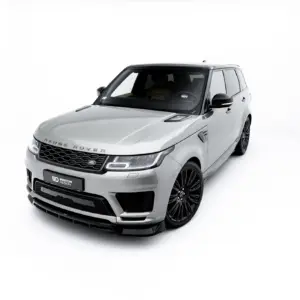 Front-left, three-quarter view of a silver Range Rover SUV in a bright white studio backdrop, showing grille and large black wheels.