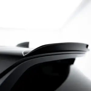 Close-up of a glossy black car roof with a shark-fin antenna visible on top edge.