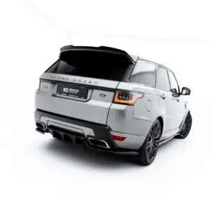 Rear-right view of a silver Range Rover SUV in a bright studio setting, showing tail lights and rear design details.