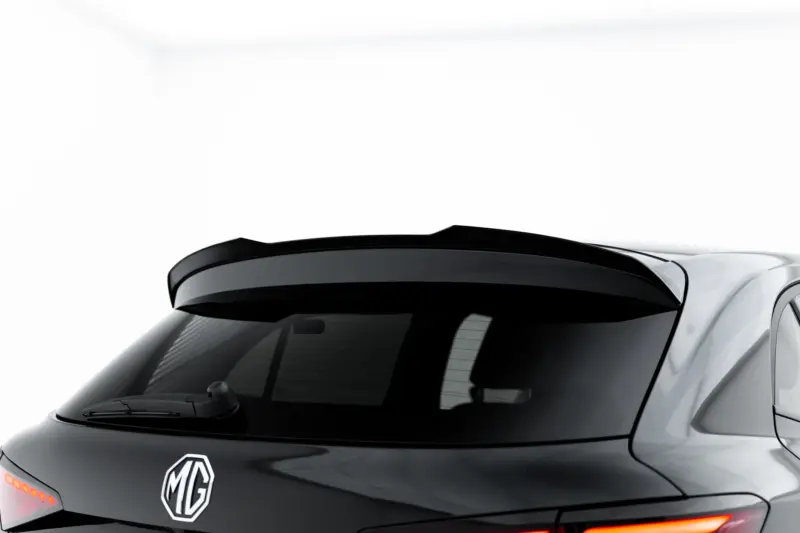 Rear view of a dark gray MG car, showing the MG emblem on the trunk and red taillights
