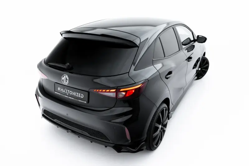 Rear three-quarter view of a sleek black MG car, showing the rear, spoiler, and illuminated taillights.