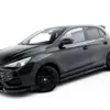 pol_po_Set-of-Splitters-MG-3-Mk1-23920_7webp - OPSHOLDERS Front three-quarter view of a dark gray sports hatchback with glossy paint, black wheels, and a bold grille on a white studio background