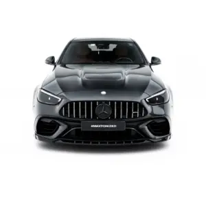 Front-on view of a dark gray Mercedes SUV, showing a large vertical grille, sculpted hood, and the #MAXTONIZED plate at the bumper edge.