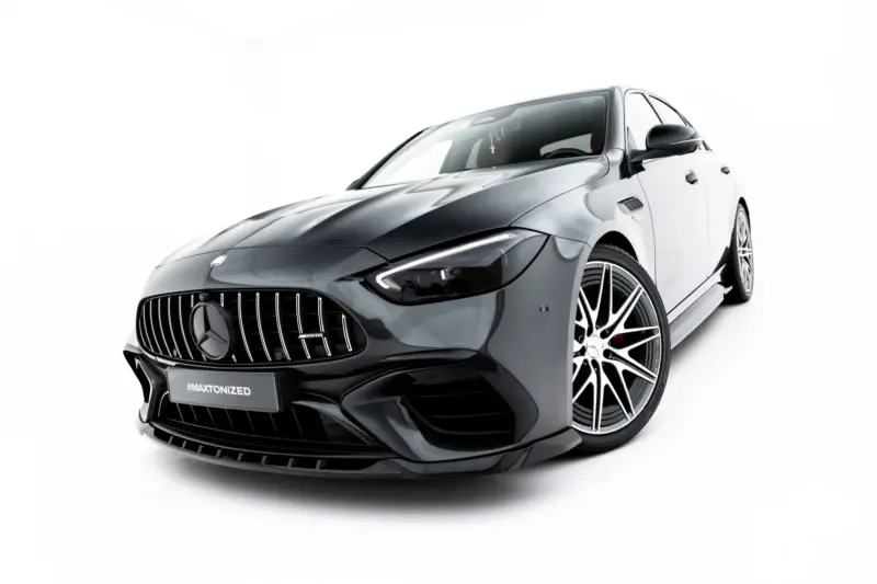 pol_po_Set-of-Splitters-Mercedes-AMG-C63-Sedan-Estate-W206-S206-23828_11webp - OPSHOLDERS Front three-quarter view of a glossy black Mercedes-AMG sports car on a white studio backdrop, highlighting the aggressive grille and angular headlights.