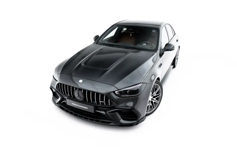 pol_po_Set-of-Splitters-Mercedes-AMG-C63-Sedan-Estate-W206-S206-23828_2webp - OPSHOLDERS Front-left angled view of a dark gray Mercedes-Benz luxury car, highlighting the prominent vertical-slat grille and glossy finish.