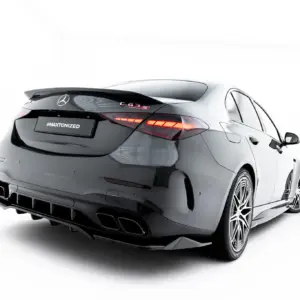 Rear three-quarters view of a gray Mercedes-Benz with red taillights and a '#MAXTONIZED' plate area, showing a sporty rear diffuser and wheels.