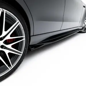 Close-up of a silver multi-spoke alloy wheel on a gray car, with a red brake caliper visible behind the rim.