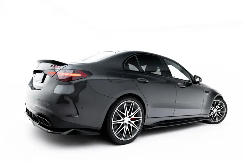 pol_po_Set-of-Splitters-Mercedes-AMG-C63-Sedan-Estate-W206-S206-23828_9webp - OPSHOLDERS Rear three-quarter view of a dark gray luxury coupe with large multi-spoke wheels against a white studio background.
