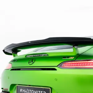 Green Mercedes-AMG rear view with a large black spoiler and taillights visible