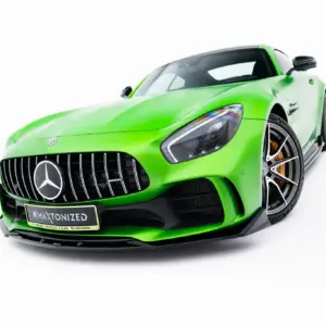 Bright green Mercedes-Benz AMG sports car shown from the front-left, highlighting the grille and large wheels in a low-angle shot.