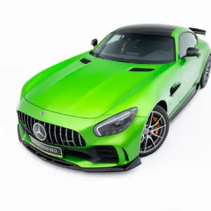 Bright green Mercedes sports car viewed from the front-left, showing a black roof and large alloy wheels.