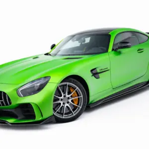 Bright green Mercedes sports car, front-left view showing grille, headlight, and large alloy wheels with orange brake calipers