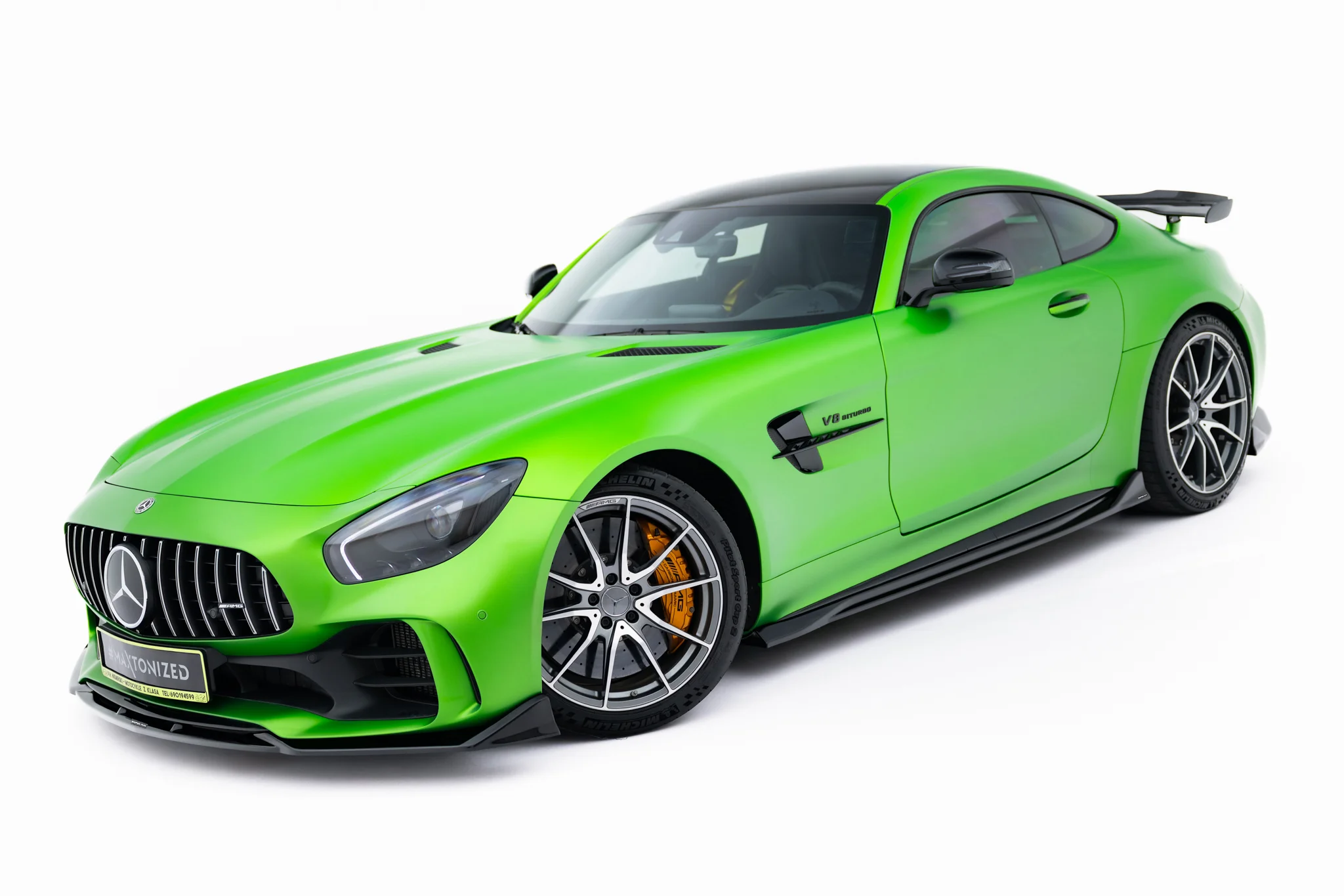 pol_po_Set-of-Splitters-Mercedes-AMG-GT-R-C190-Facelift-23894_5webp - OPSHOLDERS Bright green Mercedes sports car, front-left view showing grille, headlight, and large alloy wheels with orange brake calipers