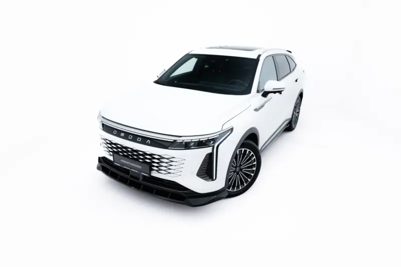 White SUV in a studio setting, front-left three-quarter view showing bold grille and large alloy wheels.