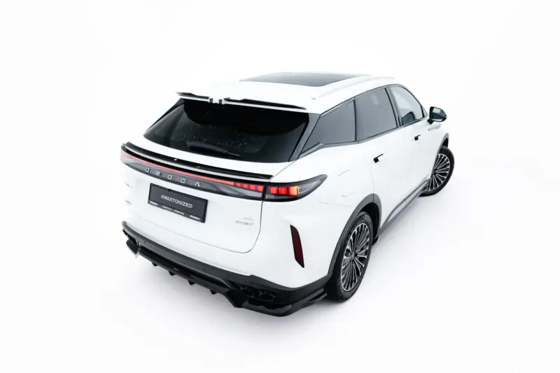 White SUV shown from the back-right angle in a studio setting, highlighting its taillights and sporty rear bumper