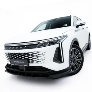 Front-left view of a white SUV showing a bold diamond-pattern grille and sharp headlight cluster