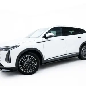 White luxury SUV photographed from a front-left angle against a white background, showcasing sleek lines and large alloy wheels.