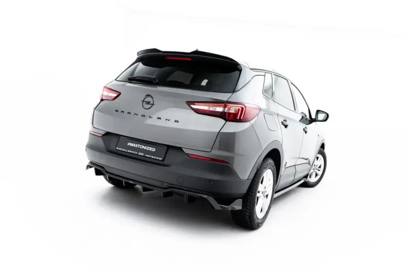 Rear three-quarter view of a silver Opel Grandland SUV with a black roof spoiler and branded license plate reading #MAXTONIZED.