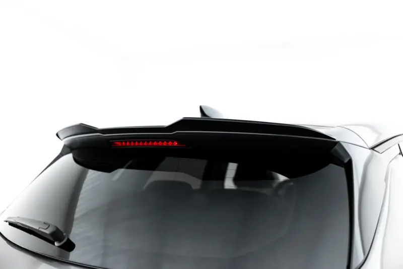 Partial rear view of a white car showing a black spoiler and a red taillight strip.