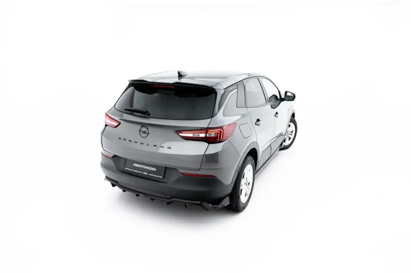 Rear three-quarter view of a silver Opel Grandland SUV against a white studio backdrop, showing taillights and rear design features.
